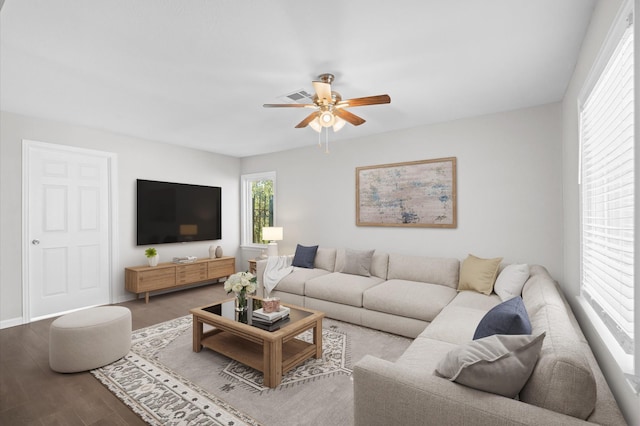 living room featuring hardwood / wood-style floors and ceiling fan