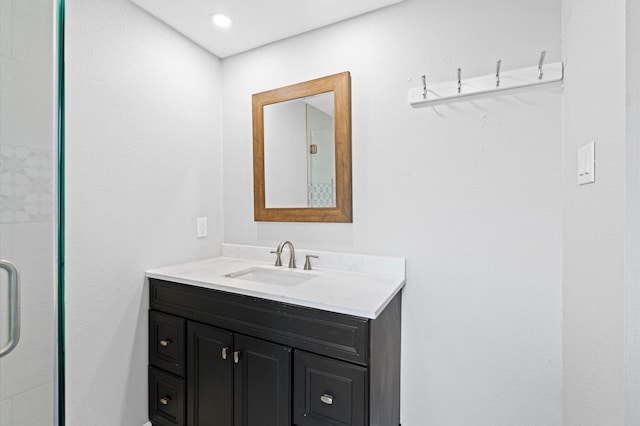 bathroom featuring vanity and an enclosed shower