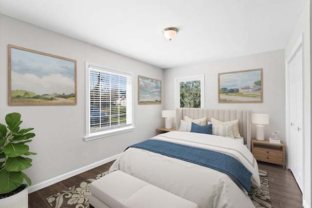 bedroom with dark hardwood / wood-style flooring