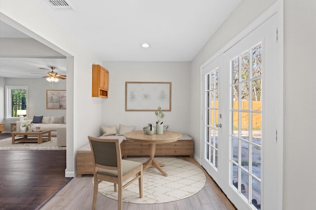 dining room with light hardwood / wood-style floors and ceiling fan