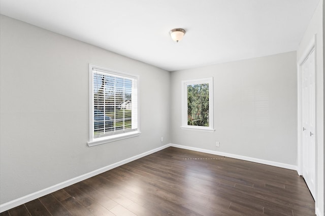 spare room with dark wood-type flooring