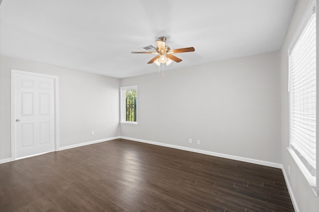 spare room with ceiling fan and dark hardwood / wood-style flooring