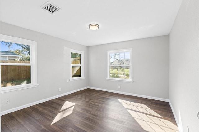 empty room with dark wood-type flooring