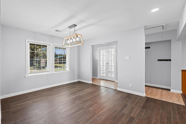 spare room featuring dark hardwood / wood-style floors and french doors