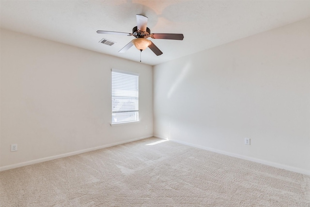 unfurnished room featuring light carpet and ceiling fan