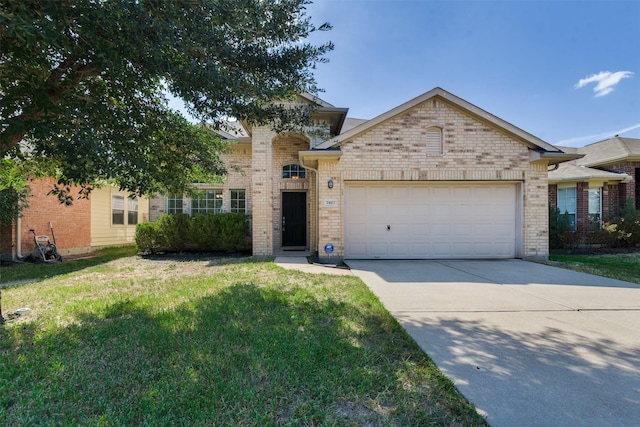 view of front of property featuring a front yard and a garage