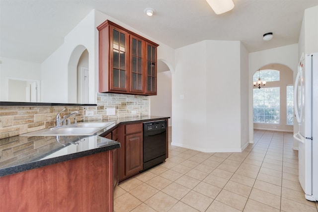 kitchen with backsplash, light tile patterned floors, white refrigerator, an inviting chandelier, and dishwasher