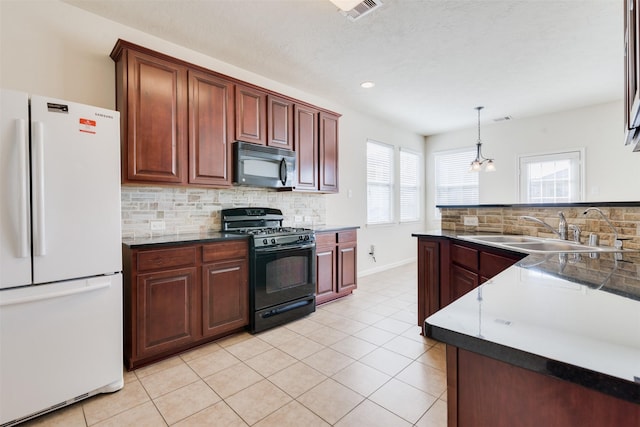 kitchen featuring black appliances, sink, decorative backsplash, decorative light fixtures, and a chandelier