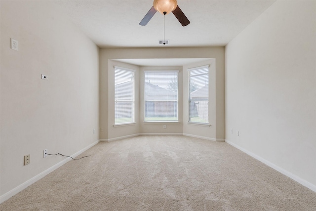 spare room with light carpet and ceiling fan