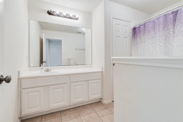 bathroom featuring tile patterned flooring, vanity, and a shower with curtain