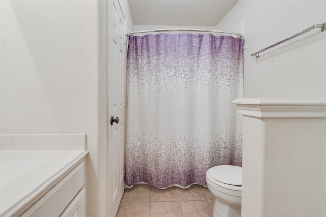 bathroom featuring tile patterned floors, vanity, and toilet