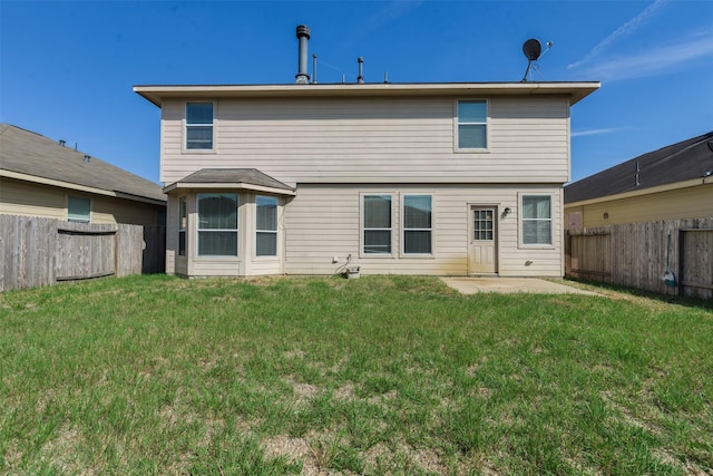 back of property with a patio and a lawn