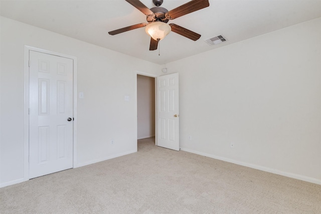 spare room with light carpet and ceiling fan