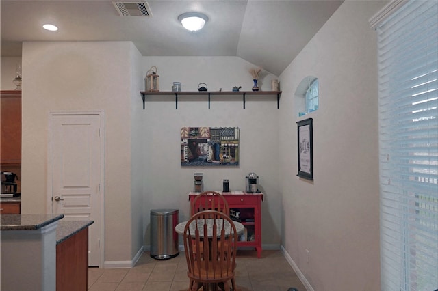 tiled dining area with lofted ceiling