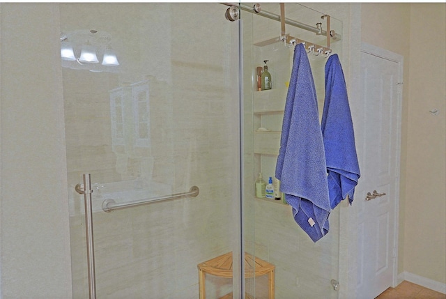 bathroom with a shower with shower door