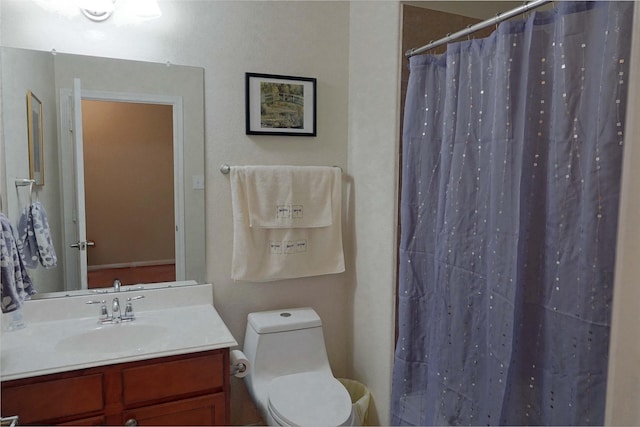 bathroom with vanity, a shower with shower curtain, and toilet