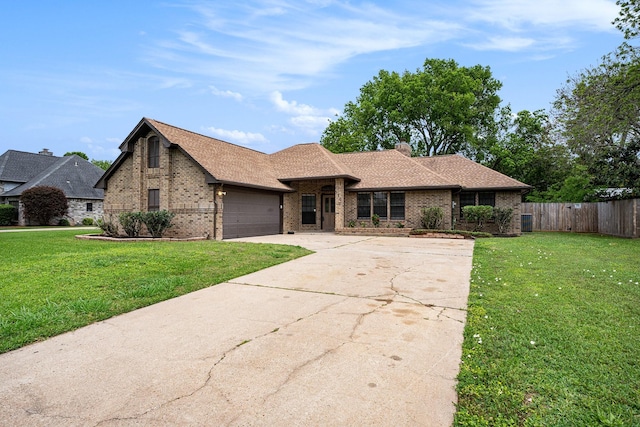 view of front facade featuring brick siding, concrete driveway, an attached garage, fence, and a front yard