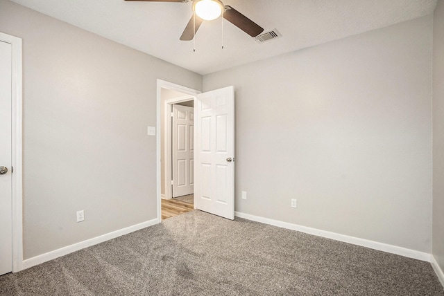 unfurnished bedroom featuring carpet floors, baseboards, and visible vents