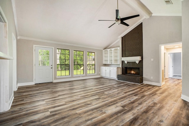 unfurnished living room with ornamental molding, a fireplace, wood finished floors, and baseboards