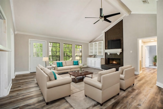 living room with a fireplace, baseboards, and ornamental molding