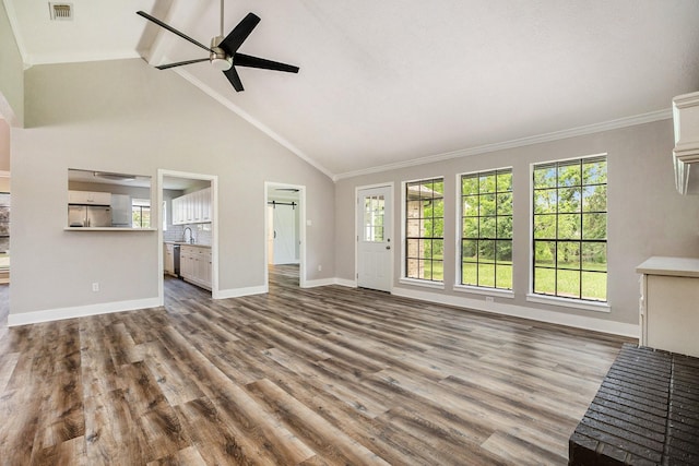 unfurnished living room with visible vents, crown molding, baseboards, and wood finished floors