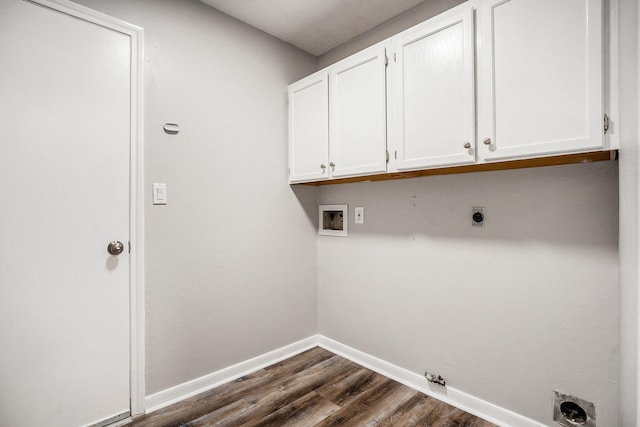 laundry area with dark wood finished floors, hookup for a washing machine, cabinet space, electric dryer hookup, and baseboards