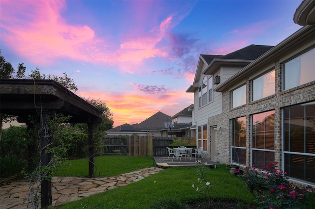 yard at dusk featuring a patio area