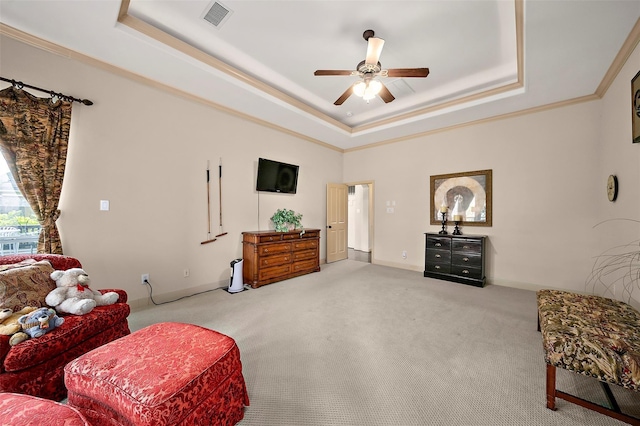 living area featuring a raised ceiling, ceiling fan, and crown molding