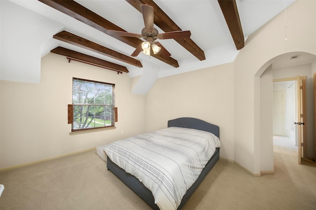 bedroom with beamed ceiling, ceiling fan, and light colored carpet