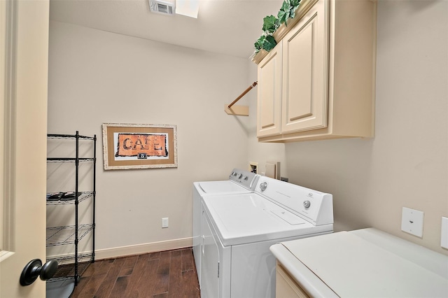 laundry area featuring cabinets, dark wood-type flooring, and washing machine and dryer