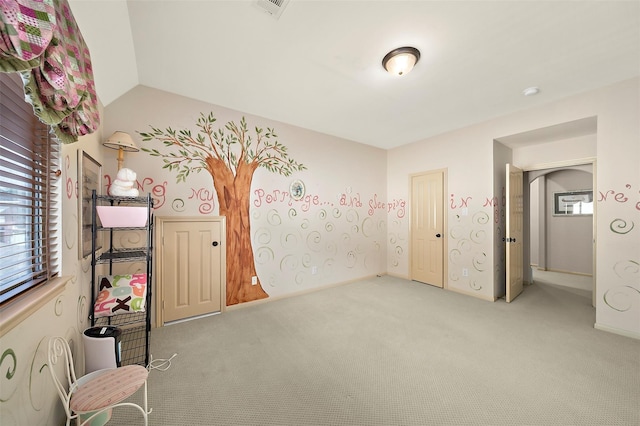 unfurnished bedroom with carpet floors and lofted ceiling