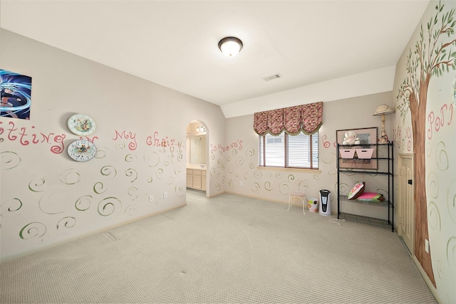 empty room featuring carpet and vaulted ceiling