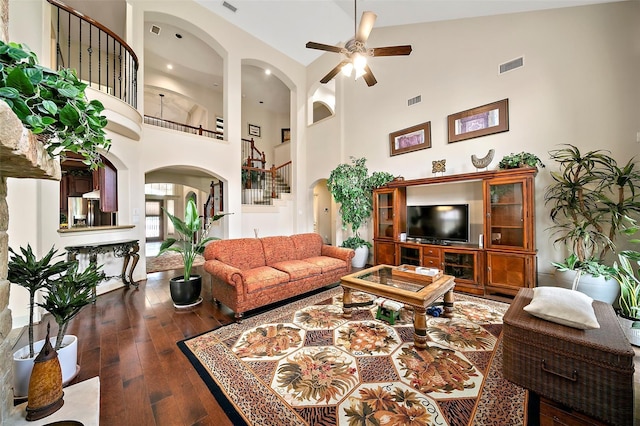 living room with ceiling fan, high vaulted ceiling, and dark hardwood / wood-style floors