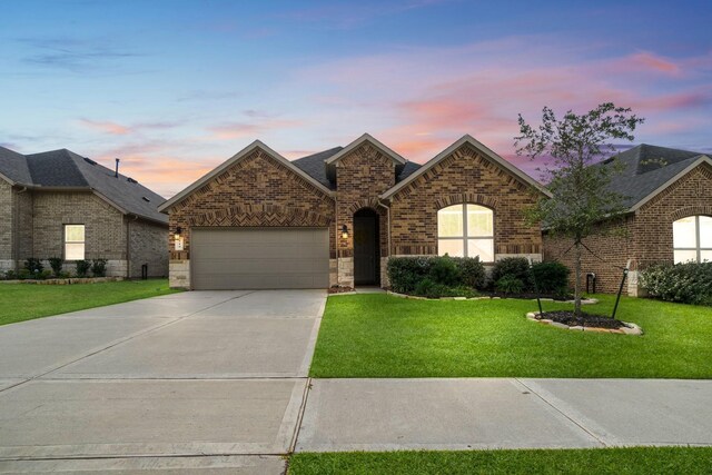 view of front facade with a lawn and a garage