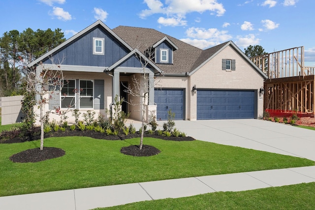 craftsman-style house featuring a front yard and a garage