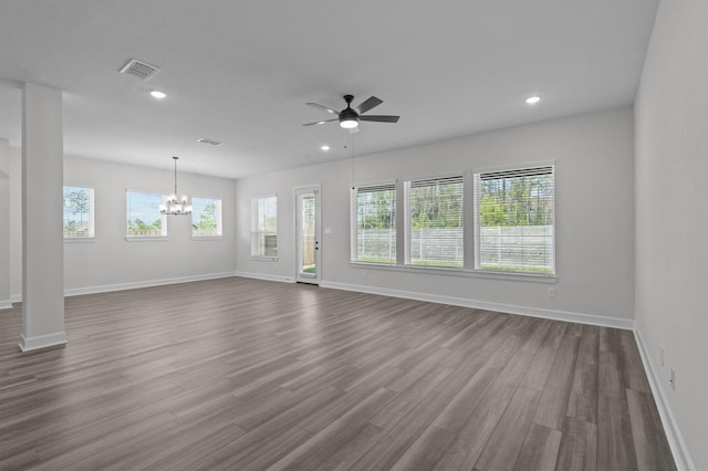 unfurnished living room with hardwood / wood-style floors and ceiling fan with notable chandelier