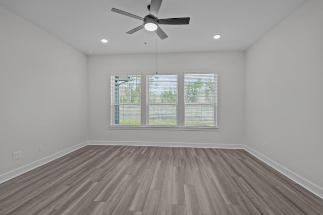 spare room featuring ceiling fan and light wood-type flooring