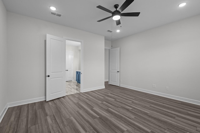 unfurnished bedroom featuring ceiling fan and dark wood-type flooring