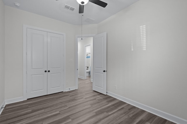 unfurnished bedroom featuring ceiling fan, a closet, and light hardwood / wood-style flooring