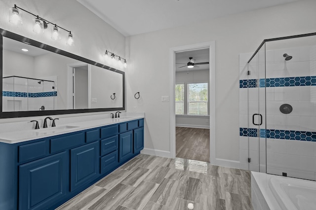 bathroom featuring ceiling fan, vanity, wood-type flooring, and shower with separate bathtub