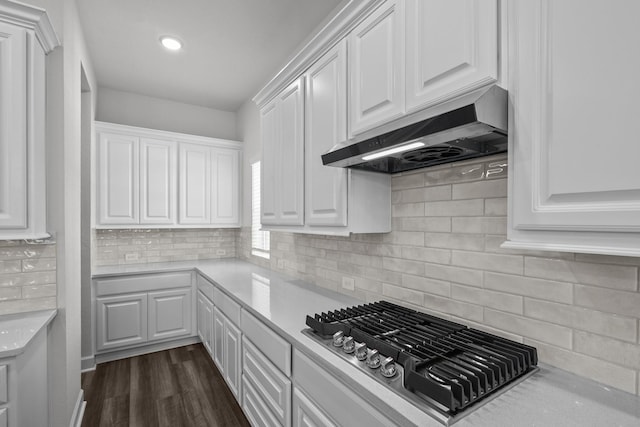 17007 Sweet Iris Ct, Conroe, TX 77302 - kitchen with under cabinet range hood, stainless steel gas cooktop, white cabinets, light countertops, and recessed lighting