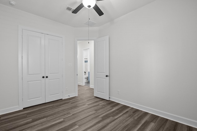 17007 Sweet Iris Ct, Conroe, TX 77302 - unfurnished bedroom featuring dark wood finished floors, a closet, baseboards, and a ceiling fan