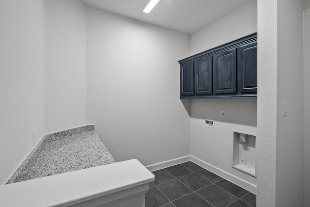 17007 Sweet Iris Ct, Conroe, TX 77302 - washroom with cabinet space, dark tile patterned floors, hookup for a washing machine, and baseboards