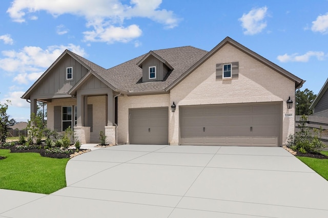 17007 Sweet Iris Ct, Conroe, TX 77302 - view of front of home featuring concrete driveway, a front lawn, board and batten siding, an attached garage, and a shingled roof