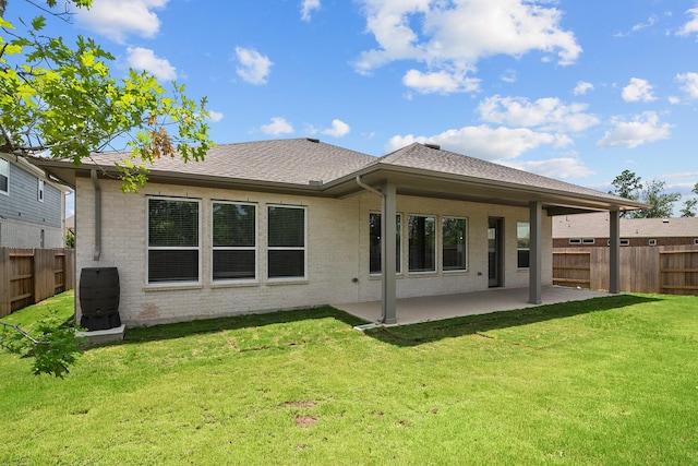 17007 Sweet Iris Ct, Conroe, TX 77302 - back of property featuring a patio area, brick siding, and roof with shingles