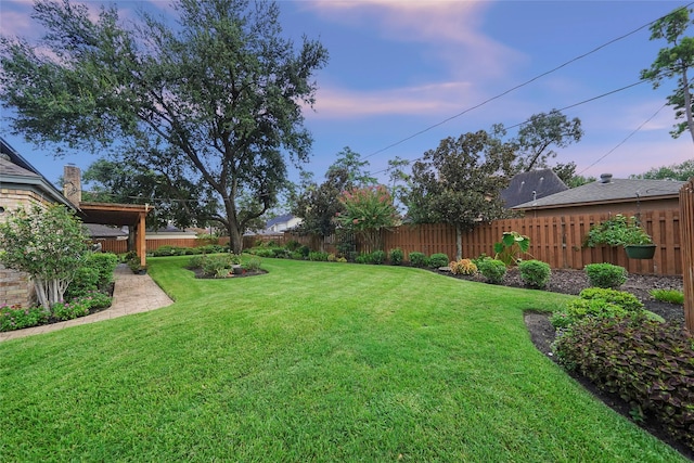 view of yard at dusk