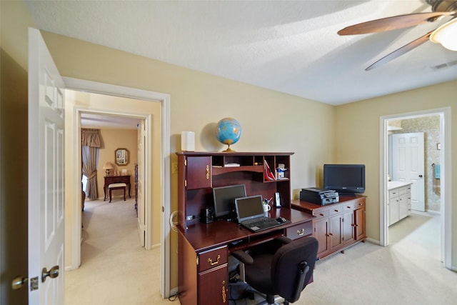 carpeted office featuring ceiling fan