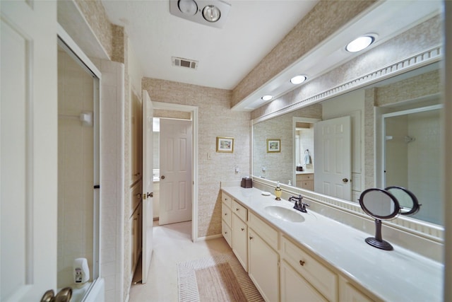 bathroom featuring a shower, vanity, and tile patterned flooring