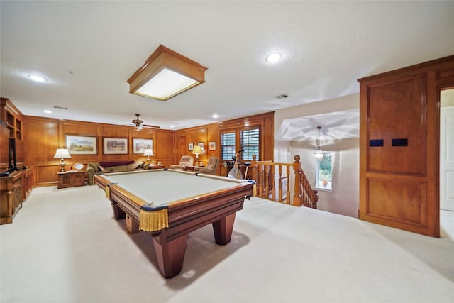 game room featuring ceiling fan, pool table, light carpet, and wooden walls