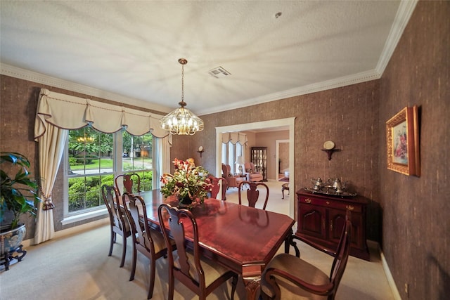 carpeted dining area with ornamental molding and a chandelier